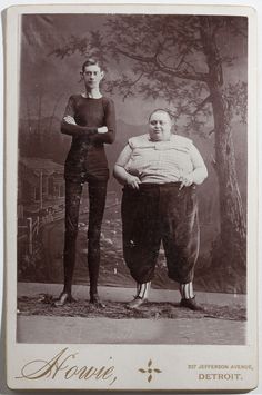 an old photo of two people standing next to each other