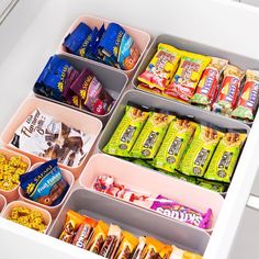 an open drawer filled with snacks and candy bar's on top of each other