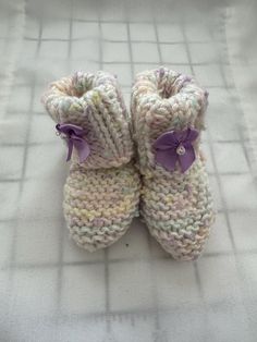 These hand-knitted baby booties are a must-have for any parent looking for a unique and personalized touch to their baby's wardrobe. The hand-knitted design adds a special touch to the booties, making them stand out from mass-produced items. The hand-knitted process also ensures that each pair of booties is unique, making them a one-of-a-kind addition to your baby's wardrobe. The hand-knitted baby booties are not only stylish but also comfortable and practical. The soft and cozy material ensures that your baby's feet stay warm and comfortable, while the non-slip design provides added safety and stability for your little one. The booties are also easy to put on and take off, making them a convenient choice for parents on the go. These hand-knitted baby booties are perfect for any occasion, Cute White Booties For Gift, Cute White Booties As A Gift, Cute White Booties As Gift, Handmade Casual Booties As Gift, Comfortable Round Toe Booties As Gift, White Booties As Winter Gift, White Winter Booties As A Gift, White Winter Booties As Gift, Handmade Knitting Pattern Yarn Gift