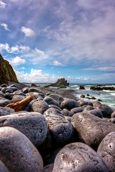 the rocks are lined up on the beach