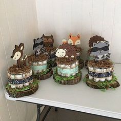 a table topped with cakes covered in frosting and animals on top of grass next to each other