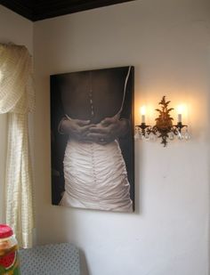 a painting hanging on the wall next to a chair