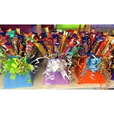 assorted candy and candies are on display in small gift bags with ribbons tied around them