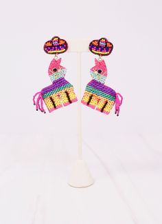 This party piñata earring is so bright and colorful! It is embellished with sequins and has a beaded sombrero. Dimensions: 3" long Playful Summer Party Jewelry, Adjustable Fun Party Earrings, Summer Party Beaded Dangle Earrings, Multicolor Novelty Earrings, Dangle Beaded Earrings For Summer Parties, Handmade Multicolor Beaded Earrings For Party, Whimsical Multicolor Festival Earrings, Party Earrings With Colorful Beads, Party Colorful Beaded Earrings