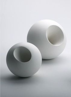 three white vases sitting next to each other