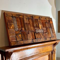 a large wooden box sitting on top of a mantle