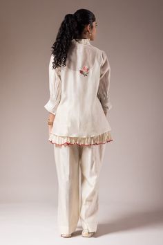 White shirt style top with pleated collar and maala style embroidery. Paired with a small cotton crushed inner and cotton flared pant. - Aza Fashions Cotton Blouse With Pintucks For Work, Cotton Blouse With Embroidered Cuffs For Work, Elegant Cotton Sets With Pallu Detail, Cotton Blouse With Floral Embroidery For Work, Elegant Cotton Tops For Festive Occasions, Elegant Cotton Top With Chikankari Embroidery, Spring Cotton Kurta For Work, Elegant Cotton Top With Resham Embroidery, Elegant Cotton Tops With Embroidered Cuffs