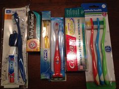 four toothbrushes in different packaging on a table