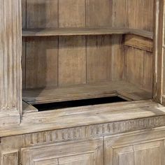 an old wooden cabinet with two shelves and one door open to reveal the bottom shelf