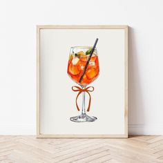 a watercolor painting of a cocktail in a glass with a straw and orange peel