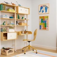 a child's room with a desk, chair and bookshelf in it