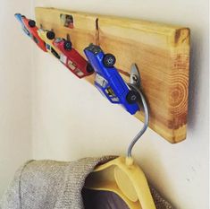 a coat rack with toy cars hanging on it