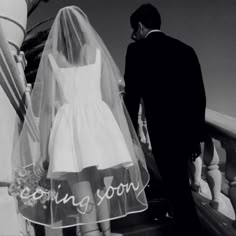 a bride and groom walking down an escalator with the word coming soon written on it