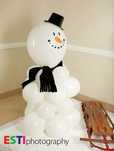 a snowman made out of balloons on the ground