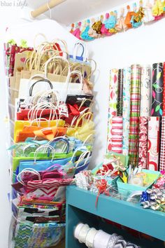 many bags and purses are on display in the closet, with ribbons hanging from the ceiling