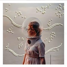 a woman in a white dress is wearing a clear headgear with flowers on it