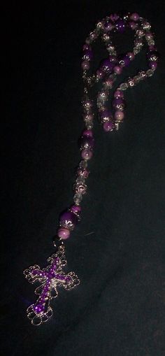 Cross is 2 in long 1 1/2 in wide  Purple  Necklace is -19 in long beads-8mm Mix colors purple glass-2mm , Clear beads 2 mm, Silver flower caps , Center piece Purple Beaded Chain Bracelet With Round Beads, Purple Beaded Chain Bracelets With Round Beads, Adjustable Purple Faceted Beads, Purple Faceted Round Beads, Purple Round Faceted Beads, Spiritual Purple Spacer Beads, Bohemian Purple Polished Beads, Purple Beaded Necklaces With Round Beads, Purple Beaded Oval Jewelry