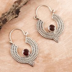 These red garnet hoop earrings look like they came out of a raja's treasure chest. Designed by Neetu Barathi of New Delhi, they feature a dot-and-strip pattern on sterling silver crescents, accented with a gemstone and small triangles. Temple Jewelry Hoop Earrings For Festivals And Gifts, Small Hoop Jewelry For Festivals As Gifts, Small Hoop Jewelry For Festivals And Gifts, Festival Gift Small Hoop Jewelry, Red Sterling Silver Jewelry For Festivals, Chandbali Hoop Earrings With Oxidized Finish For Gift, Traditional Red Hoop Earrings As Gift, Red Chandbali Hoop Earrings As Gift, Teardrop Oxidized Hoop Earrings As Gift