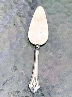 a silver spoon sitting on top of a table