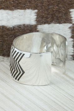 This sterling silver bracelet was made by Navajo silversmith Freddie Douglas. The inside is signed and stamped sterling.Size: 5 1/2" (will fit up to a 6 5/8" wrist)Gap: 1 1/8"Width: 1 3/8"Free shipping on all orders! We ship with USPS and always include tracking. All orders ship within a day of payment.Returns are accepted up to 30 days after you receive your order. Just send us a message. Our shop offers cash back or store credit. The item must be returned in new condition. Silver Inlay Cuff Bracelet Bangle, Southwestern Silver Cuff Bracelet With Inlay, Unique Sterling Silver Cuff Bracelet With Inlay, Sterling Silver Wide Band Bracelet, Sterling Silver Inlay Bracelets In Silver Color, Artisan Silver Cuff Bracelet With Inlay, Artisan Silver Bracelets With Inlay, Sterling Silver Bracelet, Native American Jewelry