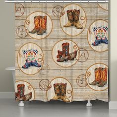 a shower curtain with cowboy boots on wooden planks and circles in the center,