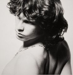 a black and white photo of a woman with curly hair