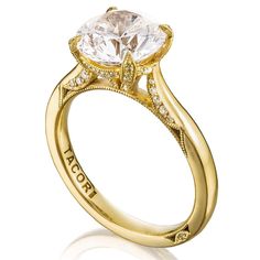 a yellow gold ring with an oval cut diamond in the center