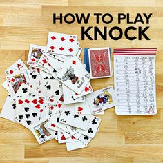 a pile of playing cards sitting on top of a wooden floor