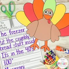 a turkey writing activity with markers and crayons on a wooden table next to it