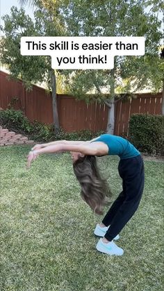 a woman doing a handstand in the yard