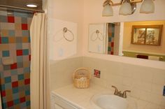 a bathroom with a sink, mirror and shower