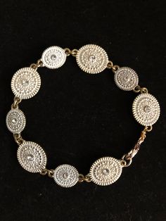 This white disk bracelet has just a hint of dazzle to brighten up your day. Looks great alone or stacked with other bracelets on your wrist. The jewelry I make is typically on the smaller side. I've spent years searching for bracelets that don't fall off of my wrist and earrings that aren't too big.  If you're looking for something similar but in a larger size, just let me know! White Metal Charm Bracelet, Gold Jubilee Bracelet, Adjustable Round Jubilee Stretch Bracelet, Adjustable Metal Charm Bracelet, Silver Adjustable Stretch Bracelet, Adjustable Silver Stretch Bracelet, Adjustable Silver Round Stretch Bracelet, Adjustable White Round Chain Bracelet, Disc Bracelet