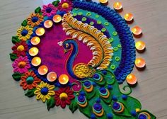 a colorful peacock made with candles on a table