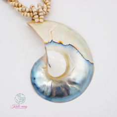 The White Nautilus shell is from the south of Thailand and partly from the Philippines and crafted in Indonesia. The Necklace is made of small white Racine beads and strung together with each bead to be a beading line and twisting each line to be one line for stronger and look beautiful, and it is 18 inches long, weight 45g. (including pendant) It's a real seashell from farming which it's fed by seaweed, not from the natural environment due to environmental conservation. Our product was crafted with craftsmanship from one generation to one generation, and it may not last forever. Unlike a product that is made by machine. It's not just an ordinary necklace but it's about the taste of the wearer. It's for you or anyone who infatuates nature and each of the shells may lookalike but not exactl Nautilus Shell, Look Alike, Nautilus, Natural Environment, Handmade Pendants, Pearl White, Sea Shells, Shells, Jewelry Necklace Pendant