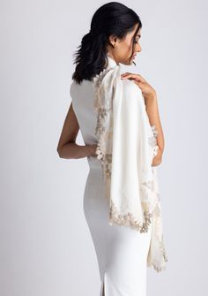 This classic ivory scarf is crafted from a luxurious blend of wool and silk, providing a soft and cozy feel. It features an exquisitely handcrafted triple-colored scalloped lace border in the perfect blend of earthy tones with an interplay between beige, natural, and alabaster. This versatile accessory is perfect for elevating any ensemble, making it a timeless must-have addition to any wardrobe, ideal for any occasion. Elegant Off-white Silk Dupatta, Elegant Off White Silk Dupatta, Cream Silk Scarf For Formal Occasions, Elegant Cream Scarf For Formal Occasions, Elegant Cream Dupatta With Lace Work, White Silk Pashmina Shawl, Elegant Cream Silk Scarf, Elegant White Pashmina Dupatta, Elegant Beige Dupatta With Lace Work