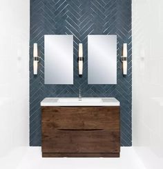 a bathroom vanity with two mirrors above it