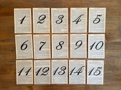 twelve books with numbers on them sitting on top of a wooden table