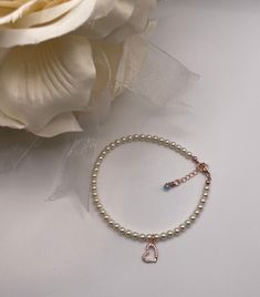 ~ This anklet is an accent to her beautiful princess bridal gown and shoes. The anklet features 4 mm Swarovski crystal pearls and a Cubic Zirconia framed horseshoe. Each anklet is hand-made and made to order ~Please specify white or Ivory Swarovski crystal pearl  ~Rose Gold lobster clasp....comes with 1 inch rose gold extender with blue Swarovski Crystal    ~ Comes with something blue card and may personalize card ~Please let me know the anklet size. To measure for the anklet sizes- wrap a ribbon or string around your ankle, mark it with a pen, measure it and add 1/2" for comfort-loose fit or exact fit  ~Each anklet will arrive in a box tied with a ribbon perfect for gift giving and dust cover pouch ~Please read our policies for information on international shipping, returns, and exchanges Dainty Adjustable Heart Bracelet For Wedding, Elegant Heart-shaped Anklets For Party, Dainty Adjustable Anklets For Wedding, Elegant Heart-shaped Party Anklets, Elegant Beaded Bracelet With Heart Charm For Wedding, Elegant Heart Charm Anklets For Valentine's Day, Elegant Wedding Beaded Bracelet With Heart Charm, Elegant Valentine's Day Party Anklets, Adjustable Pearl Bracelet For Wedding On Valentine's Day