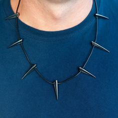 Can't get enough of Black Panther? BTW, do you know that people of Wakanda prefer a cat-alogue to e-shopping? If you plan to become Wakanda King T'Challa for Halloween or your next dress up craze ... This Authentic Marvel Claw Pendant is right up your warrior alley, my hybrid friend Spring your neck to life with the ultimate superhero-action jewelry. A one-of-a-kind claw pendant necklace, comfortable and visually packed with sharp boldness. We swear by the original T'Challa's metal claw design, Black Jewelry For Halloween Concert, Edgy Black Necklaces For Cosplay, Halloween Themed Black Necklace, Edgy Black Necklace For Cosplay, Black Themed Necklace For Halloween, Alternative Style Halloween Party Necklace, Themed Black Necklace For Halloween, Black Halloween Necklace For Concert, Black Necklaces For Halloween Concert