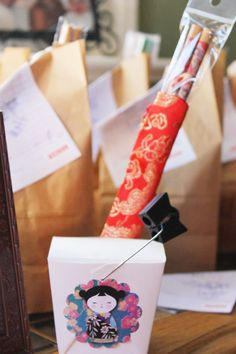 an umbrella and some paper bags on a table