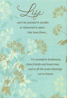 a poem written in brown and blue with flowers on the bottom, saying life can't be counted in candles or measured in years that have flow