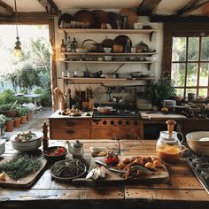 an old fashioned kitchen with many pots and pans on the stove top in front of it