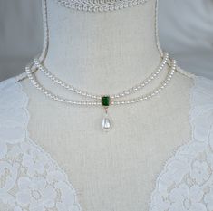 Vintage, Romantic Style Emerald Necklace, Wedding Pearl and Emerald CZ Bridal Choker, Green Emerald CZ Multi Row Vintage Pearl Necklace Materials used: - White/Ivory Cream Swarovski pearls - cubic zirconia stones - gold plated over brass The necklace will arrive packaged ready for gift giving in a delicate white jewelry box with a silver ribbon. Matching earrings for this necklace:  Back to my shop http://www.etsy.com/shop/crinadesign73 Thank you for visiting my store! Emerald Jewelry Vintage, Vintage Wedding Necklace, Emerald Jewelry Necklaces, Emerald Jewelry Necklace, Vintage Pearl Necklace, Ivory Necklace, Swarovski Pearl Necklace, Tiered Necklace, Bridal Pearl Necklace