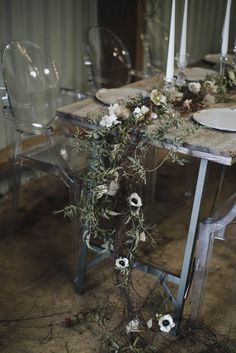 the table is set with flowers and candles