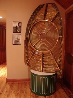 a large metal clock sitting on top of a wooden floor