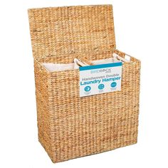 the laundry hamper is made out of wicker and has two compartments for storage