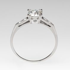 he vintage ring is centered with one (1) old mine cut diamond weighing 0.96 carat and set into a four-prong head. The shoulders of the ring are each accented with two (2), bead set, round brilliant cut diamonds. The ring measures 6.8mm at the top, rises 5.1mm above the finger, tapering to 0.8mm wide and 0.8mm thick at the base of the shank. Timeless Classic Cut Diamond Ring With Single Cut Diamonds, Timeless Diamond Ring With Vvs Clarity And Classic Cut, Timeless Diamond Ring With Single Cut, Timeless Diamond Ring With Single Cut Diamonds, Timeless Platinum Asscher Cut Diamond Ring, Timeless Rings With Classic Cut Single Diamonds, Wedding Diamond Ring With Classic Cut, Classic Style Ring With Single Cut Diamonds, Wedding Diamond Ring With Single Cut Classic Shape