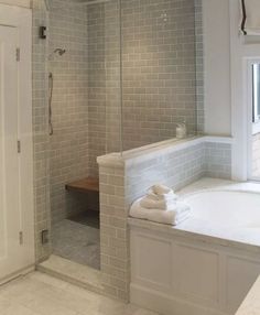 a bathroom with a walk in shower next to a bath tub