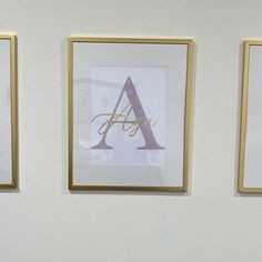 three framed letters are hanging on the wall next to each other, with one letter in gold frame