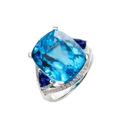 18-karat white gold, Approximate weight 2.57 grams.  Faceted swiss blue topaz, 19.05 total carat weight, 13.1 x 15.7 mm.  Round diamonds, 0.56 total carat weight, 1 mm.  Round tanzanite, 1.15 total carat weight, 5.5 mm.  Rings, 2-15.7 mm wide. Blue Topaz Rings, Topaz Rings, Swiss Blue Topaz Ring, Swiss Blue Topaz, Blue Topaz, Round Diamonds, Topaz, White Gold, Diamonds